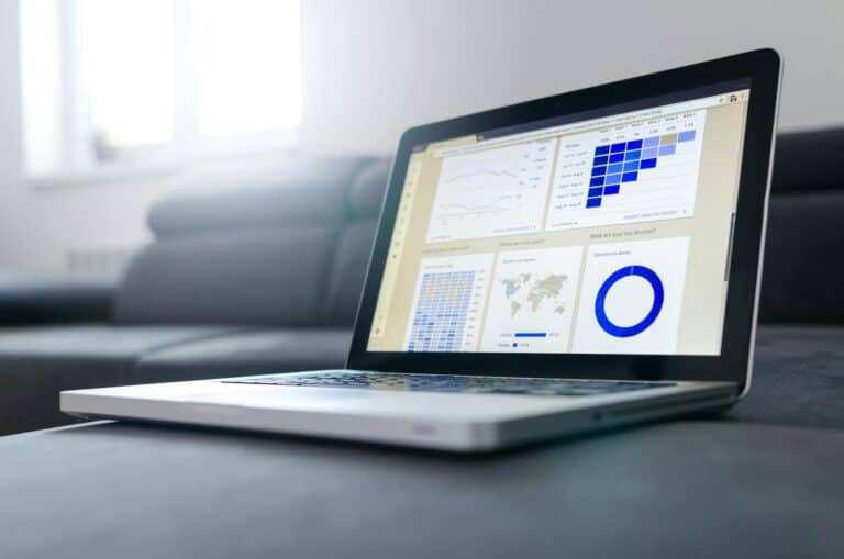 Laptop displaying analytics and data visualizations for AI search ROI measurement.